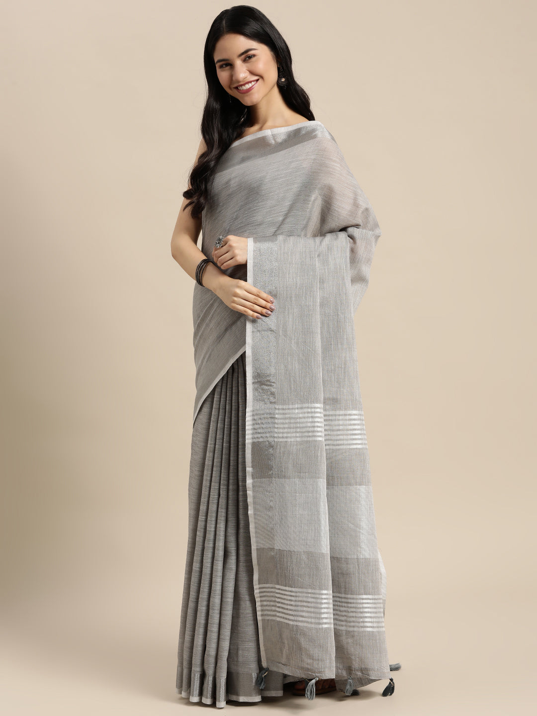 Astita Elegant Light Grey Woven Linen Saree with Contrast Zari Border & Tassels – Soft & Breathable Party Wear