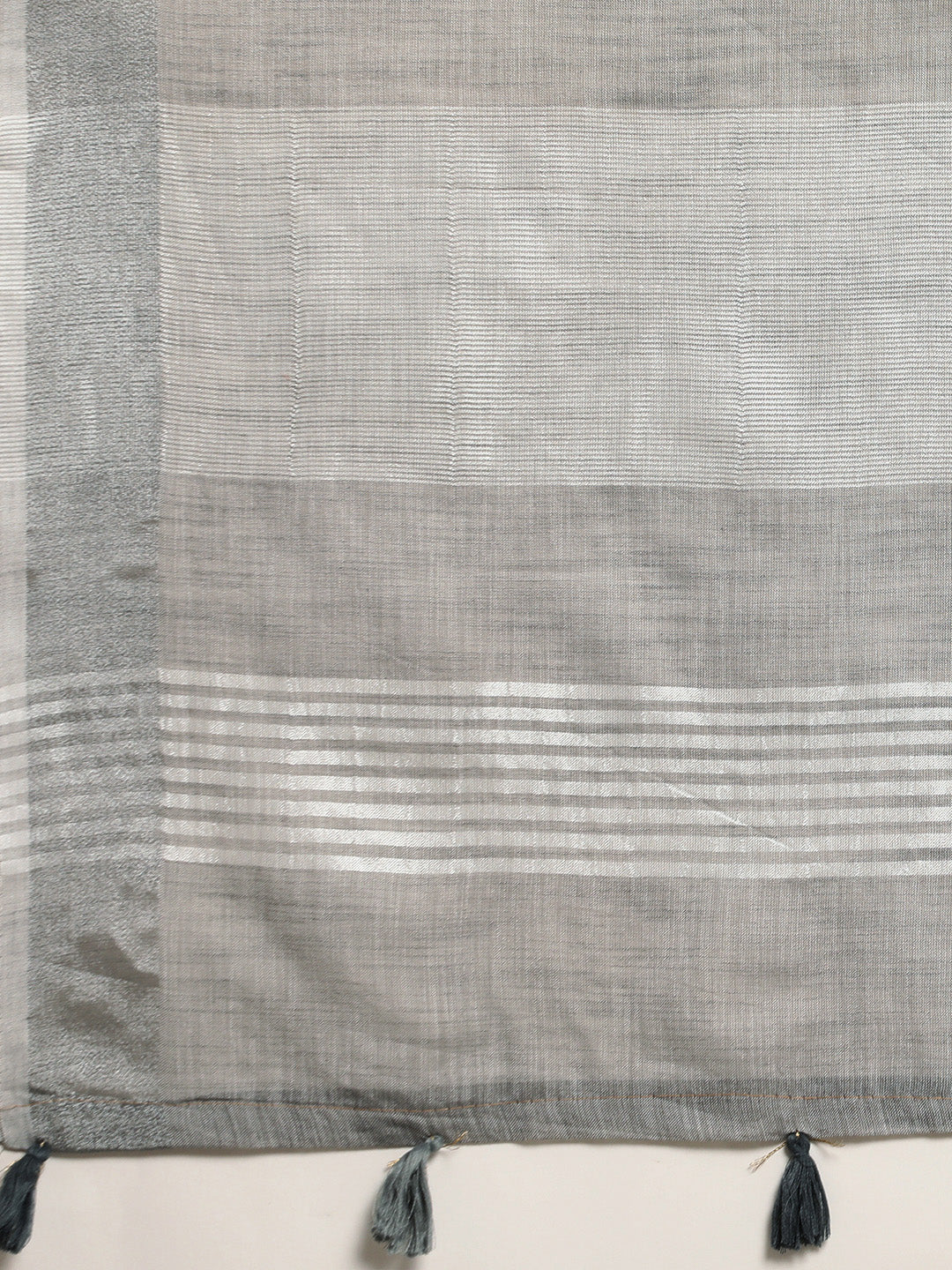 Astita Elegant Light Grey Woven Linen Saree with Contrast Zari Border & Tassels – Soft & Breathable Party Wear